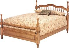 a wooden bed frame with two pillows on the headboard and foot board, against a white background