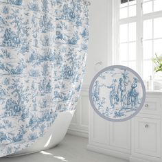 a blue and white toiler print shower curtain next to a bathtub in a bathroom