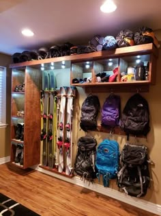 the skis are lined up on the wall behind the coat rack in the room