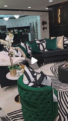 a living room filled with lots of black and white furniture next to a zebra print rug