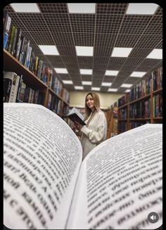 a woman reading a book in a library