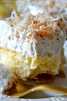 a close up of a piece of cake on a plate with a fork and spoon