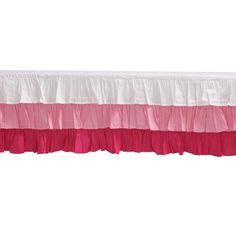 a pink and white bed skirt with ruffled edges