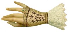 a woman's hand with lace on it and an armband that has birds on it