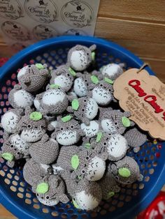 there are many small stuffed animals in the blue bowl on the table next to each other