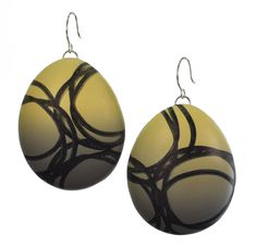 two pairs of earrings with black and yellow designs on the front, one is hanging from silver hooks