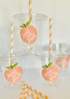 there are four cups with straws in the shape of an apple and one is labeled sweet as peach