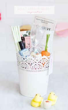 a basket filled with lots of different items on top of a white counter next to two rubber ducks