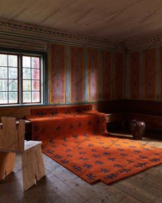 an orange rug in the middle of a room