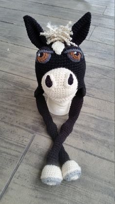 a crocheted horse head on top of a wooden floor