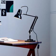 a desk lamp sitting on top of a wooden table