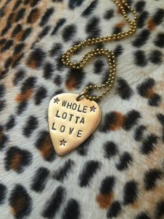 a necklace with the words whole lotta love on it