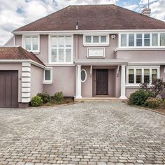 a large house with a brick driveway in front of it