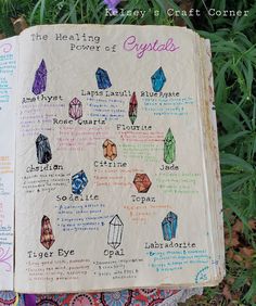 an open book with crystals on it in front of some plants and flowers, which are labeled crystal stones