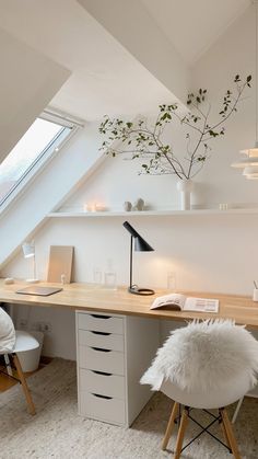 an attic office with white furniture and lots of natural light