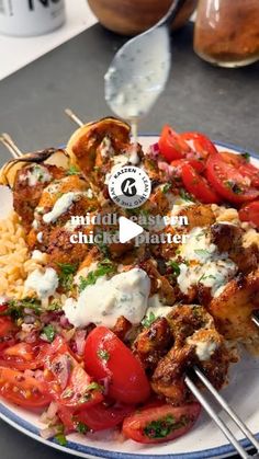 a white plate topped with meat and veggies on skewered skewers