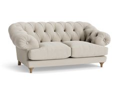 a white couch sitting on top of a wooden frame