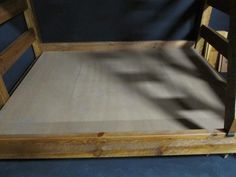 a wooden bed frame with no sheets on it and the bottom half is made out of wood