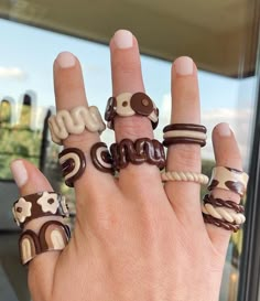 a woman's hand with rings made to look like animals