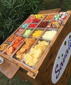 an assortment of snacks displayed on a wooden stand