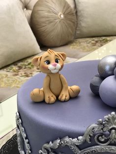 there is a cake that looks like a lion sitting on top of the table with decorations around it