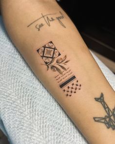 a person with a tattoo on their arm that has geometric designs and lines all over it