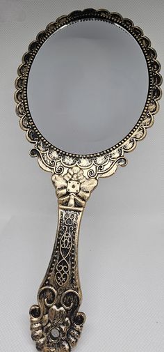 Indulge in timeless elegance with our exquisite vintage-style handheld mirror. Inspired by the charm and sophistication of bygone eras, this beautifully crafted mirror is a must-have accessory for any vanity. Whether you're a lover of antique décor or seeking a unique gift, our mirror offers a perfect blend of functionality and style. Check out my store https://www.etsy.com/uk/shop/FlutterFingersCrafts More Mirrors here https://www.etsy.com/your/shops/me/tools/listings/section:49657717 Vintage Hand Held Mirror Tattoo, Vintage Hand Held Mirror, Vintage Handheld Mirror, Mirror Tattoos, Vintage Style Mirror, Hand Held Mirror, Duo Costumes, Make Up Mirror, Handheld Mirror