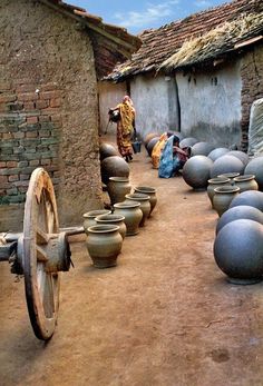 black and white photograph of pots on wheels