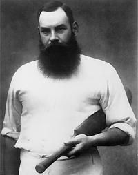 an old black and white photo of a man with a long beard holding a baseball bat