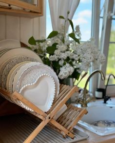 a stack of plates sitting on top of a wooden tray