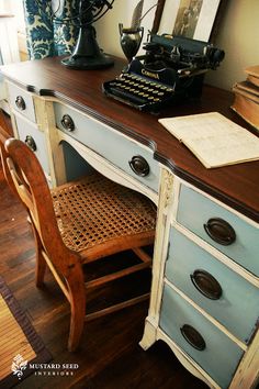 an old fashioned desk with a typewriter on it