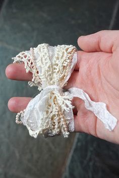 a hand holding an object with lace on it