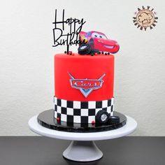 a red and black birthday cake with cars on it