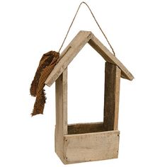 a bird house hanging from a rope on a white background