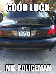 the back end of a car that is parked in a parking lot with words good luck mr policeman on it