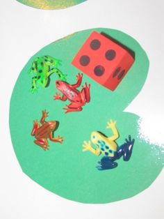 a number with different animals on it next to a dice and some other items in the shape of numbers