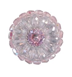 a pink crystal flower brooch on a white background