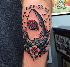 a man's arm with a shark tattoo on it and the words surf or die