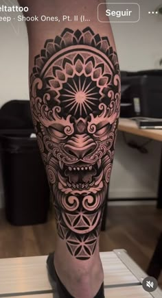 a man's leg with a tattoo on it and an image of a skull