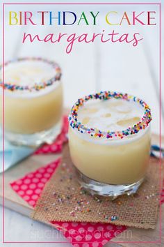 two glasses filled with cake margaritas on top of a table