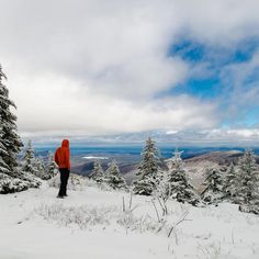 a person standing on top of a snow covered slope