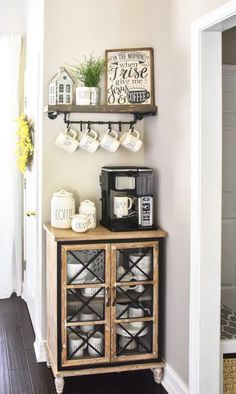 a coffee bar with two shelves holding cups and mugs on top of it next to a doorway