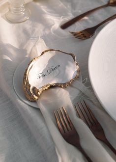 there is a place setting on the table with silverware and napkins in it