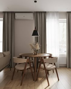 a dining room table with four chairs around it