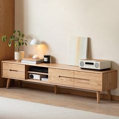 a wooden entertainment center with speakers on it