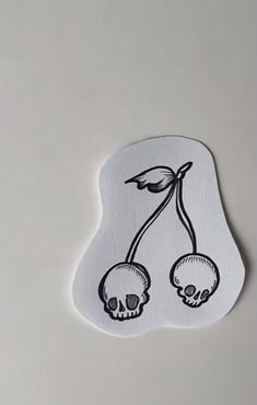 the sticker has two skulls on it and one is holding a plant with leaves