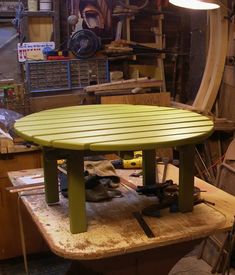 a green table sitting on top of a work bench