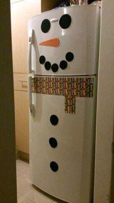 a refrigerator decorated like a snowman in the kitchen