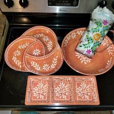 an oven with plates and napkins sitting on top of it