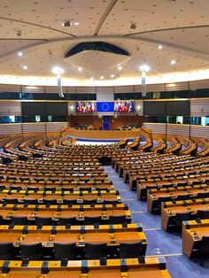 an empty room with rows of tables and chairs